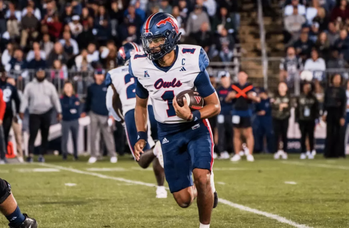 FAU’s quarterback Cam Fancher running with the ball in the 48-14 defeat by UConn on Sept. 21, 2024. 